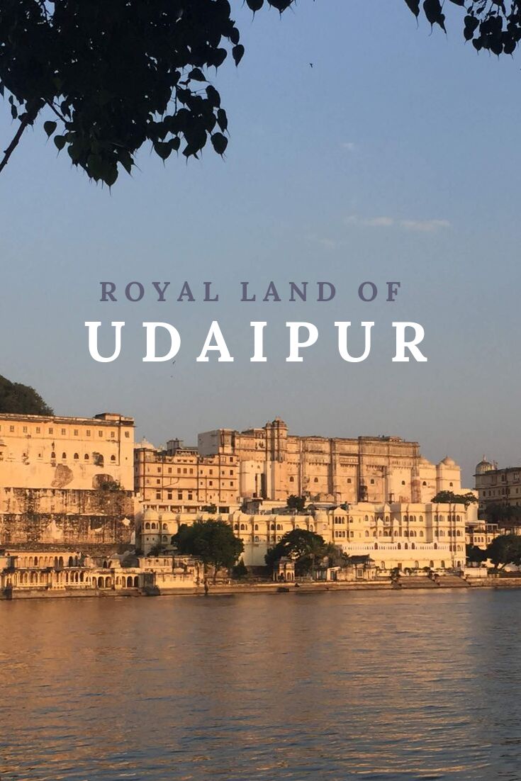 Cityscape of Udaipur with text overlay 'Royal Land of Udaipur' over a blue sky.