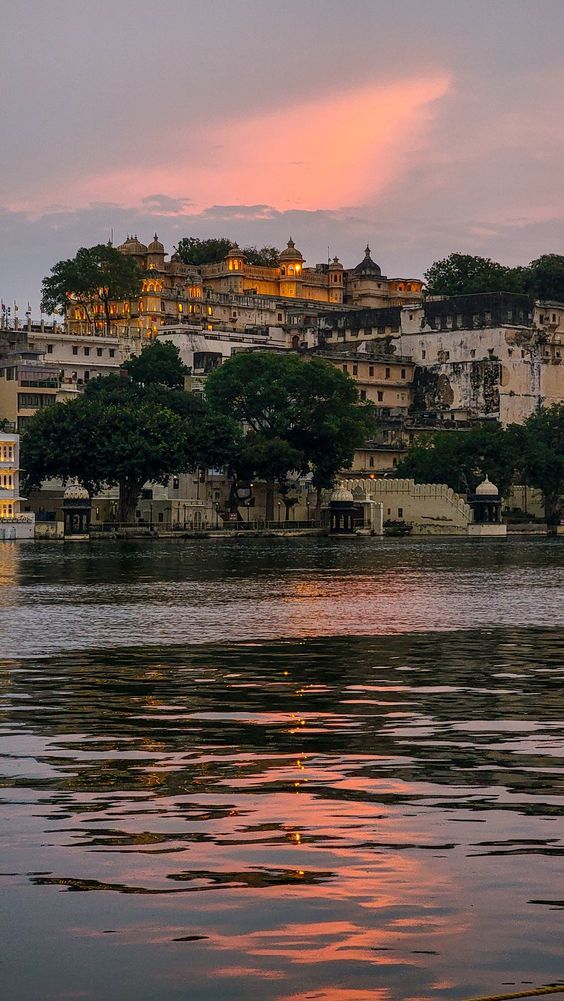 City palace reflected in water with pink sunset clouds
