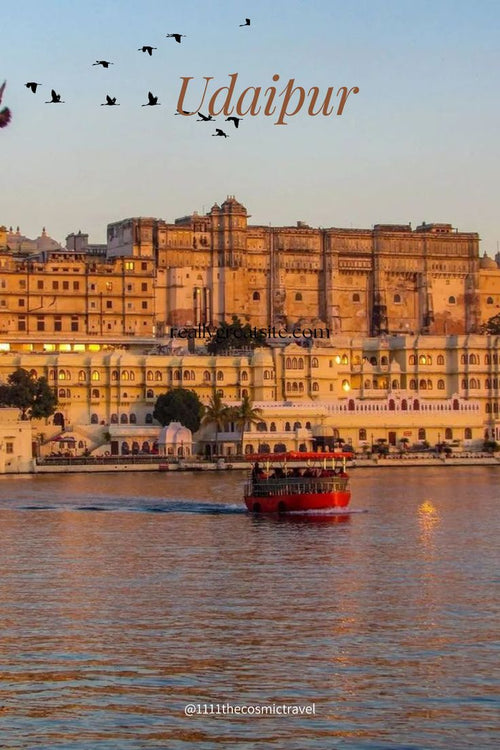 City palace in Udaipur with a boat on the lake at sunset