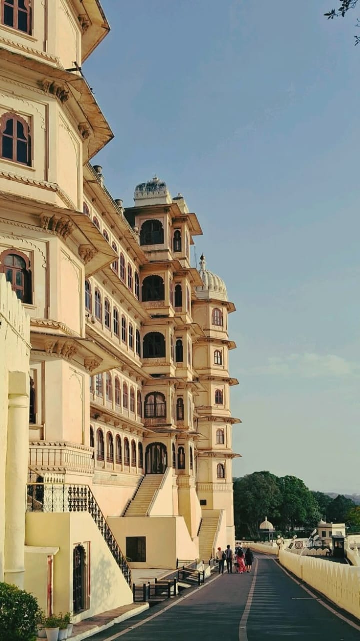 Large ornate building with multiple levels under a clear blue sky
